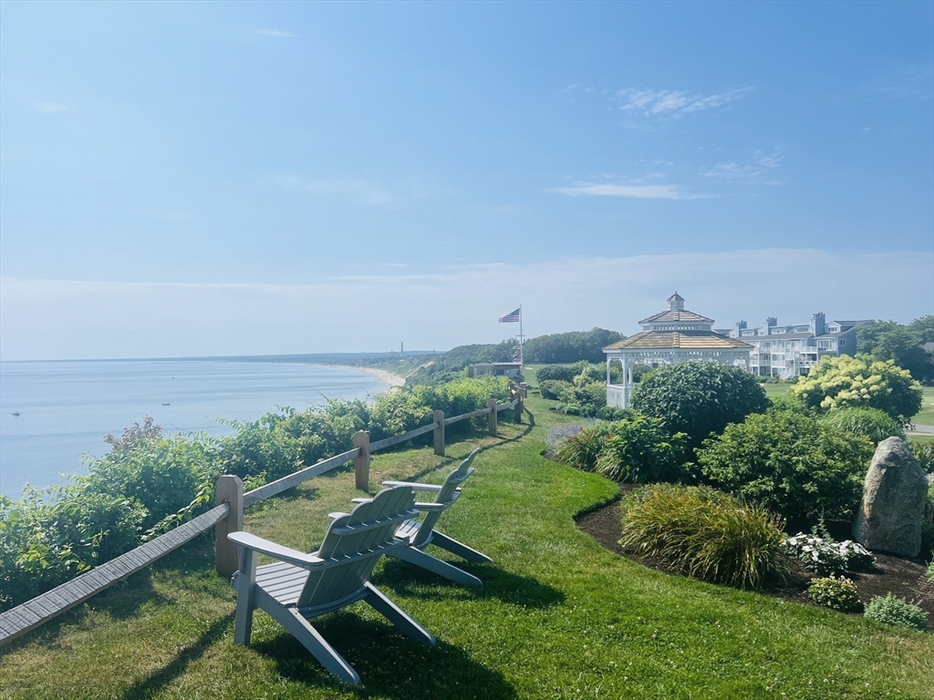 619 White Cliffs Drive, Unit 619 Plymouth, MA 02360 - Photo 2 of 42 a view of a chair and table on the green field