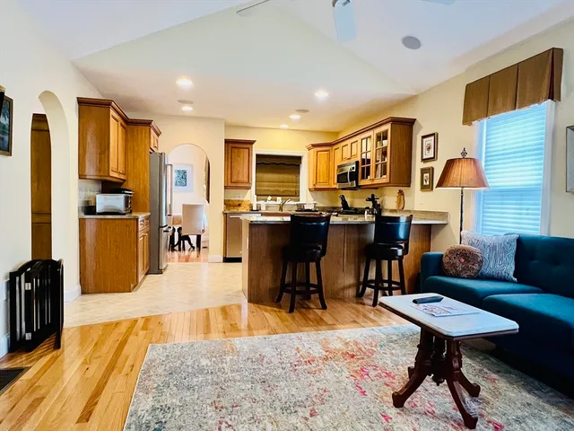 a living room with fireplace furniture and a dining table