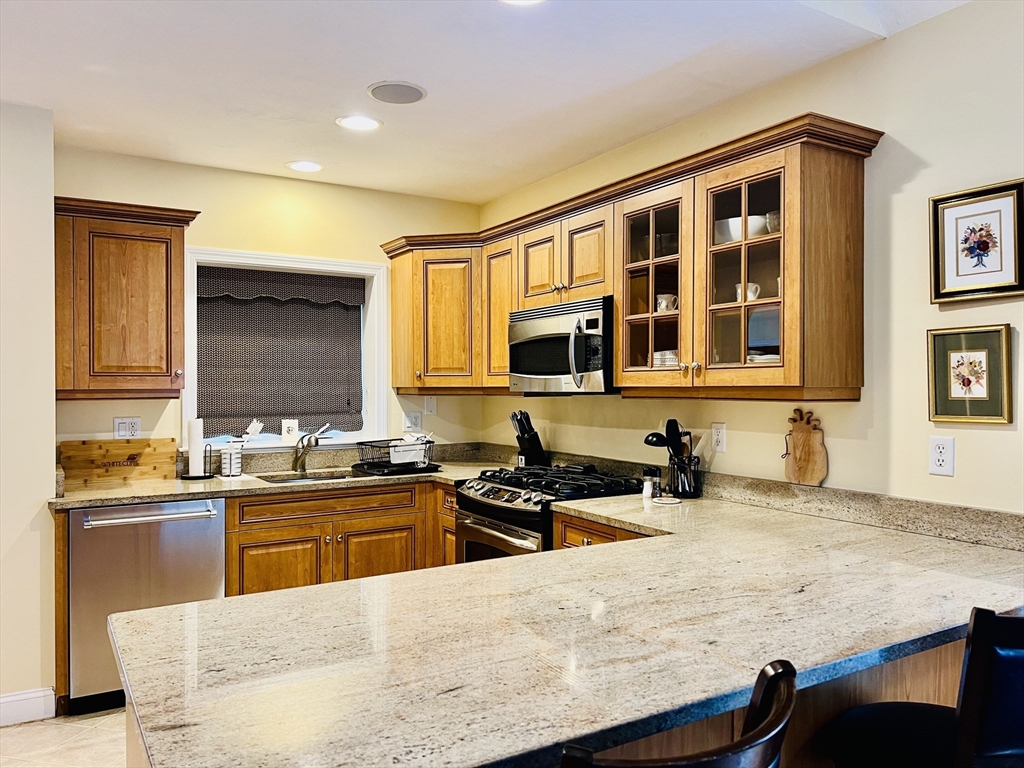 619 White Cliffs Drive, Unit 619 Plymouth, MA 02360 - Photo 22 of 42 a kitchen with a sink and a stove top oven