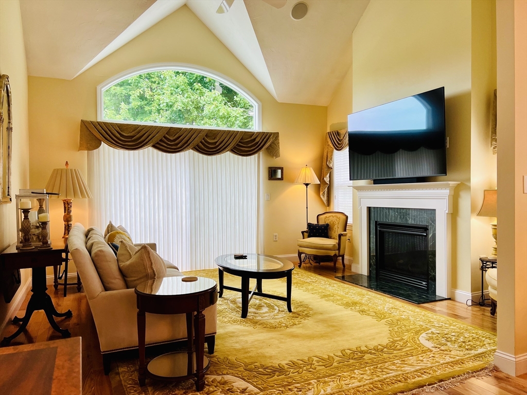 619 White Cliffs Drive, Unit 619 Plymouth, MA 02360 - Photo 24 of 42 a living room with furniture and a fireplace