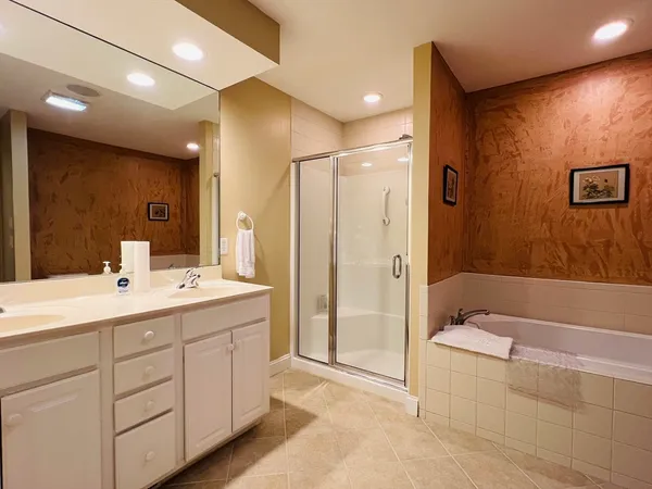 a bathroom with a double vanity sink mirror and shower