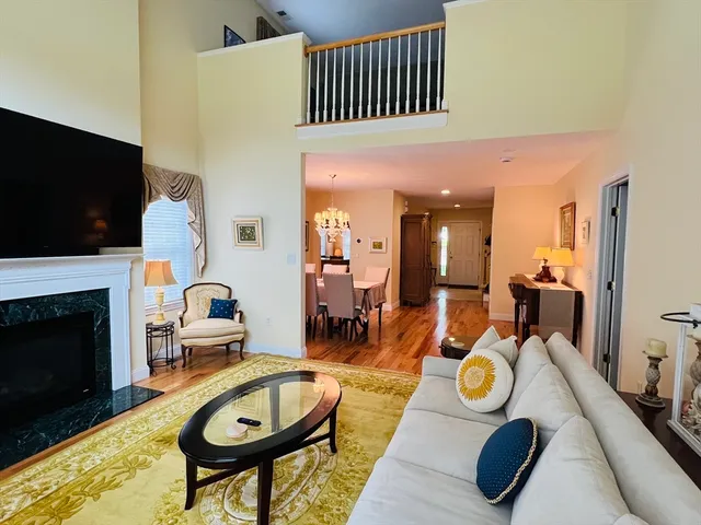 a view of a dining room with furniture a fireplace and flat screen tv