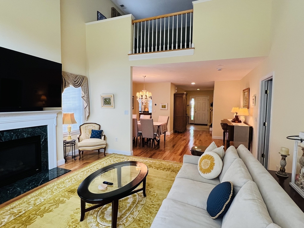 619 White Cliffs Drive, Unit 619 Plymouth, MA 02360 - Photo 31 of 42 a view of a dining room with furniture a fireplace and flat screen tv