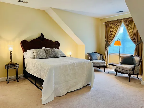 a spacious bedroom with a bed and a couch