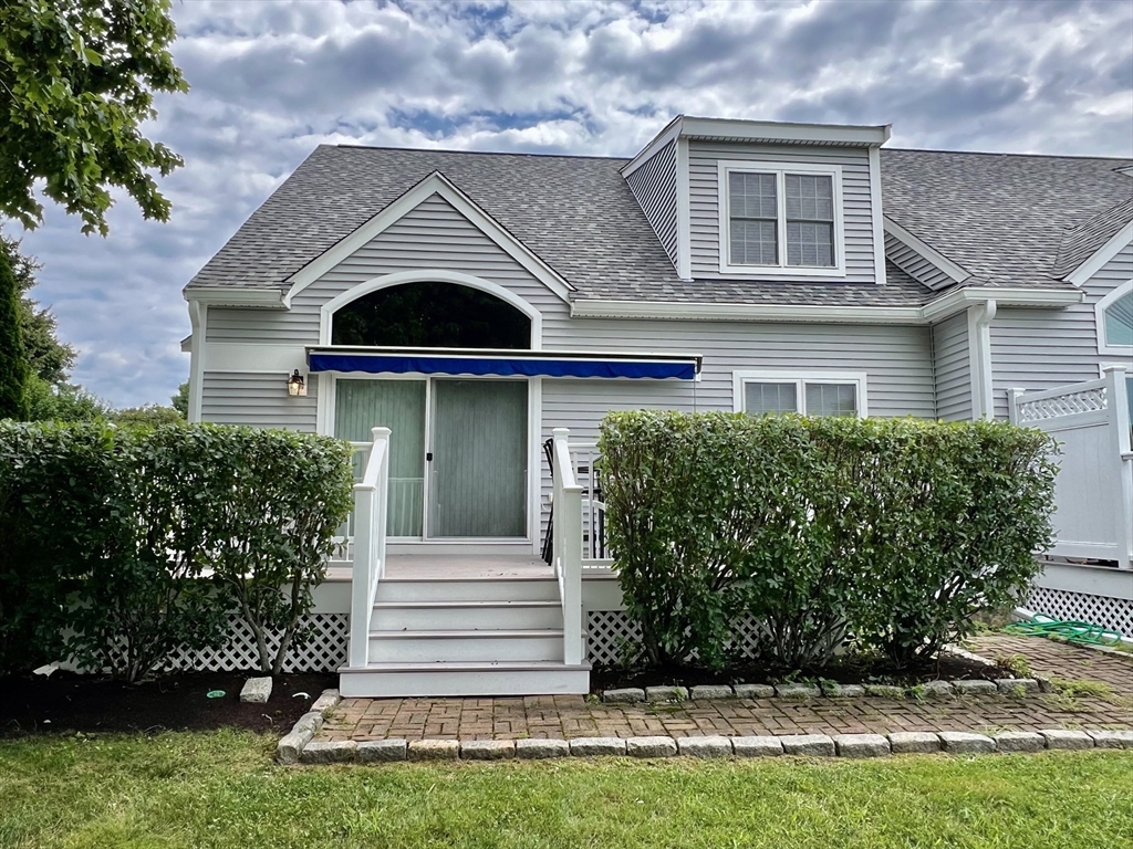 619 White Cliffs Drive, Unit 619 Plymouth, MA 02360 - Photo 39 of 42 a front view of a house with a garden
