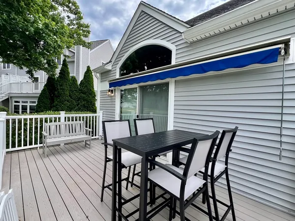 a view of a chair and table on the deck