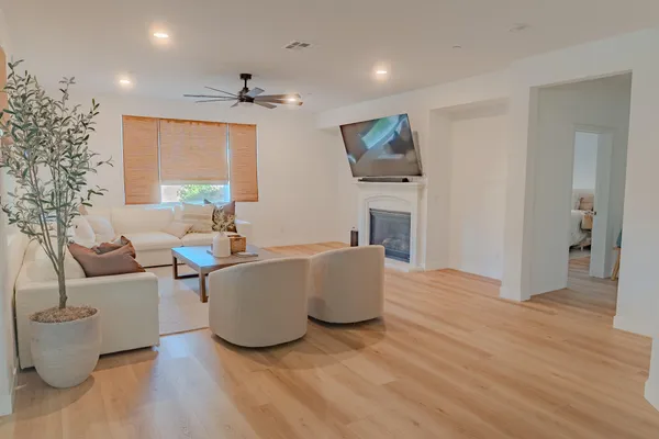 a living room with furniture and a wooden floor