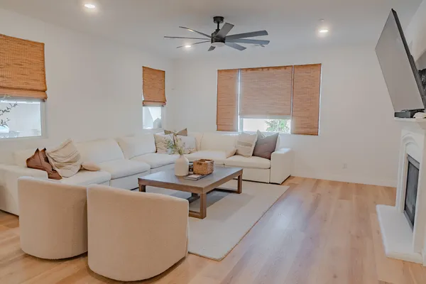 a living room with furniture a large window and a flat screen tv