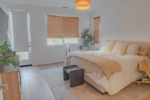 a bedroom with a bed and a potted plant