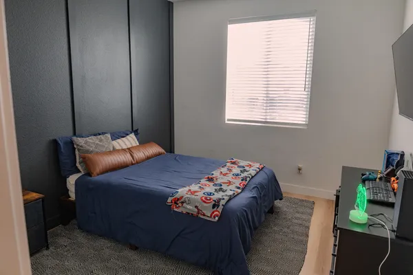 a bed sitting in a bedroom next to a window