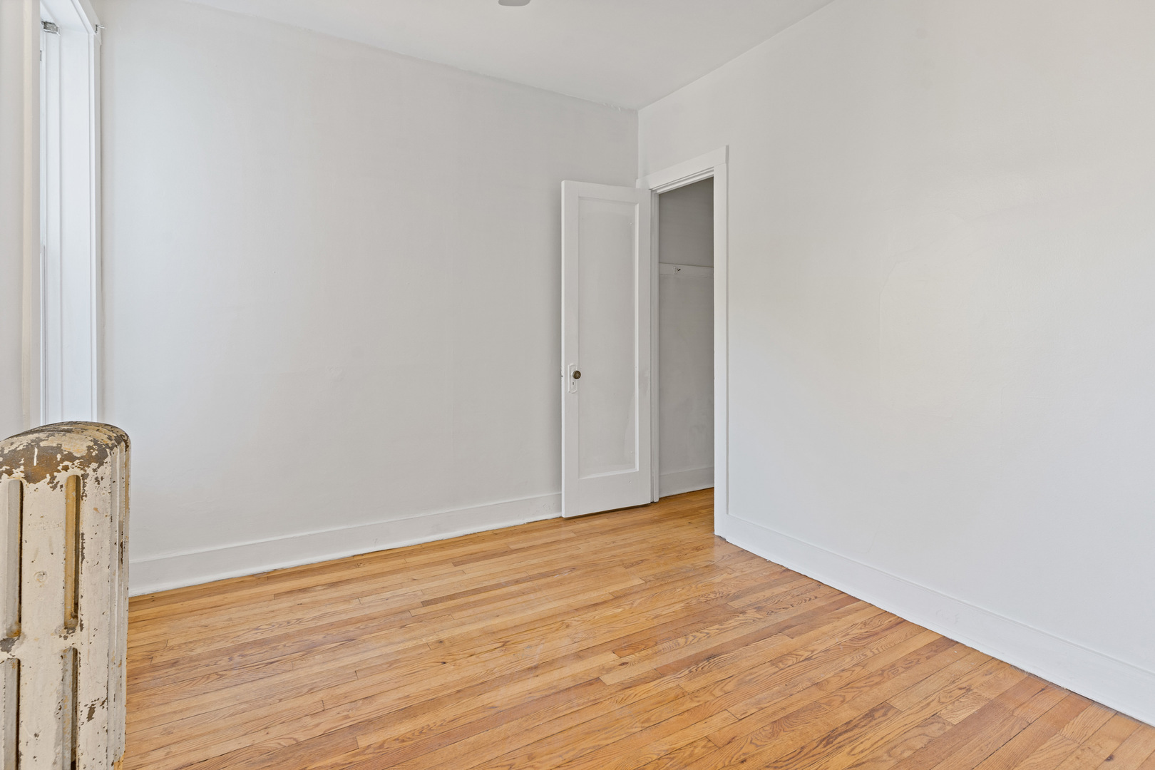10342 South Calumet Avenue, Unit 3 Chicago, IL 60628 - Photo 11 of 25 a view of empty room with wooden floor