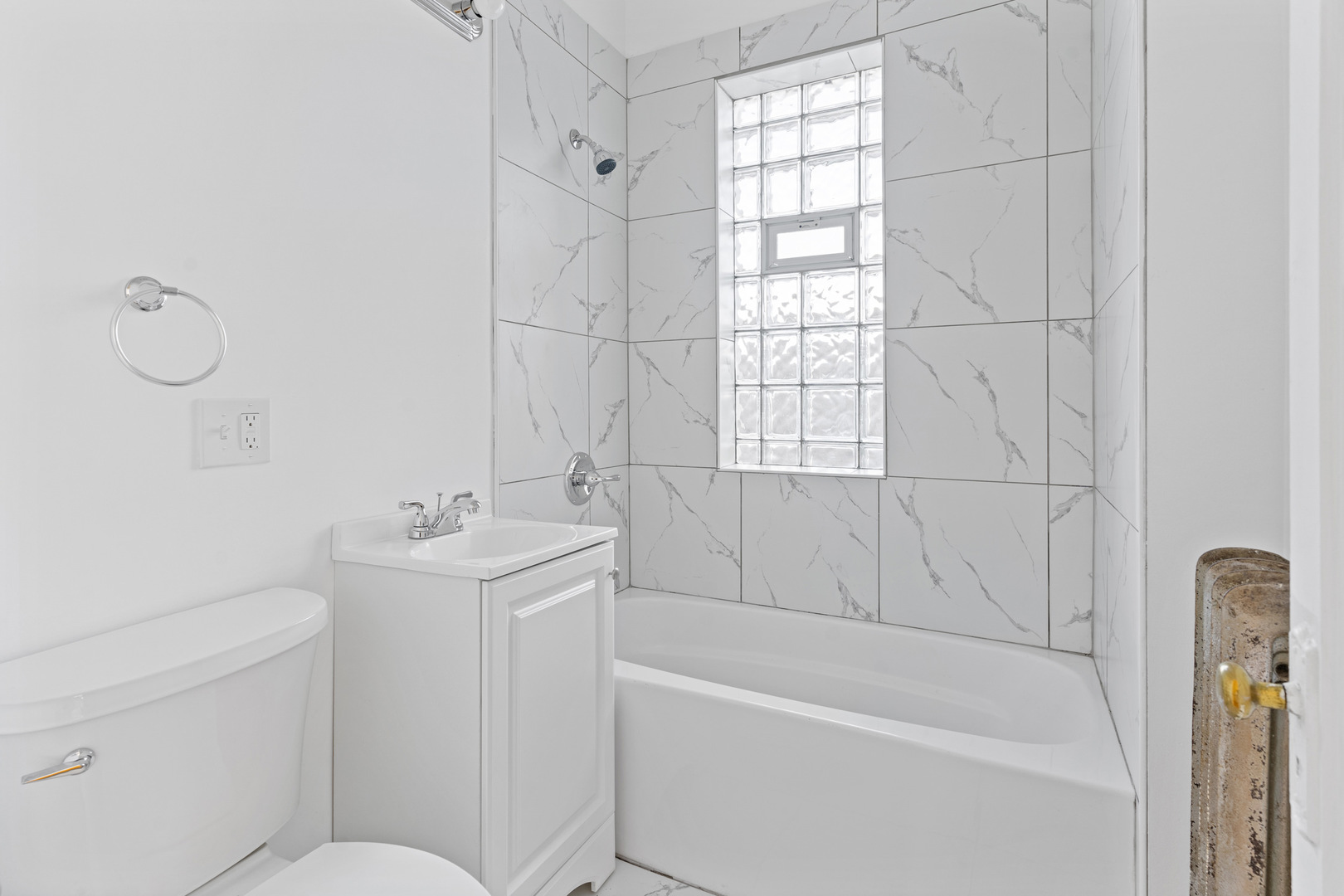 10342 South Calumet Avenue, Unit 3 Chicago, IL 60628 - Photo 12 of 25 a bathroom with a sink a toilet and tub