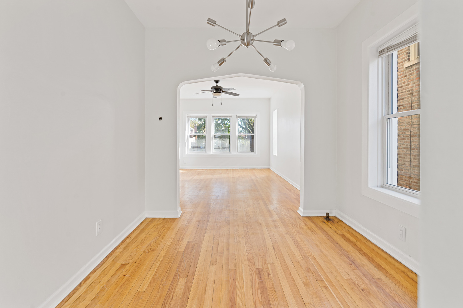 10342 South Calumet Avenue, Unit 3 Chicago, IL 60628 - Photo 17 of 25 wooden floor in an empty room with a window