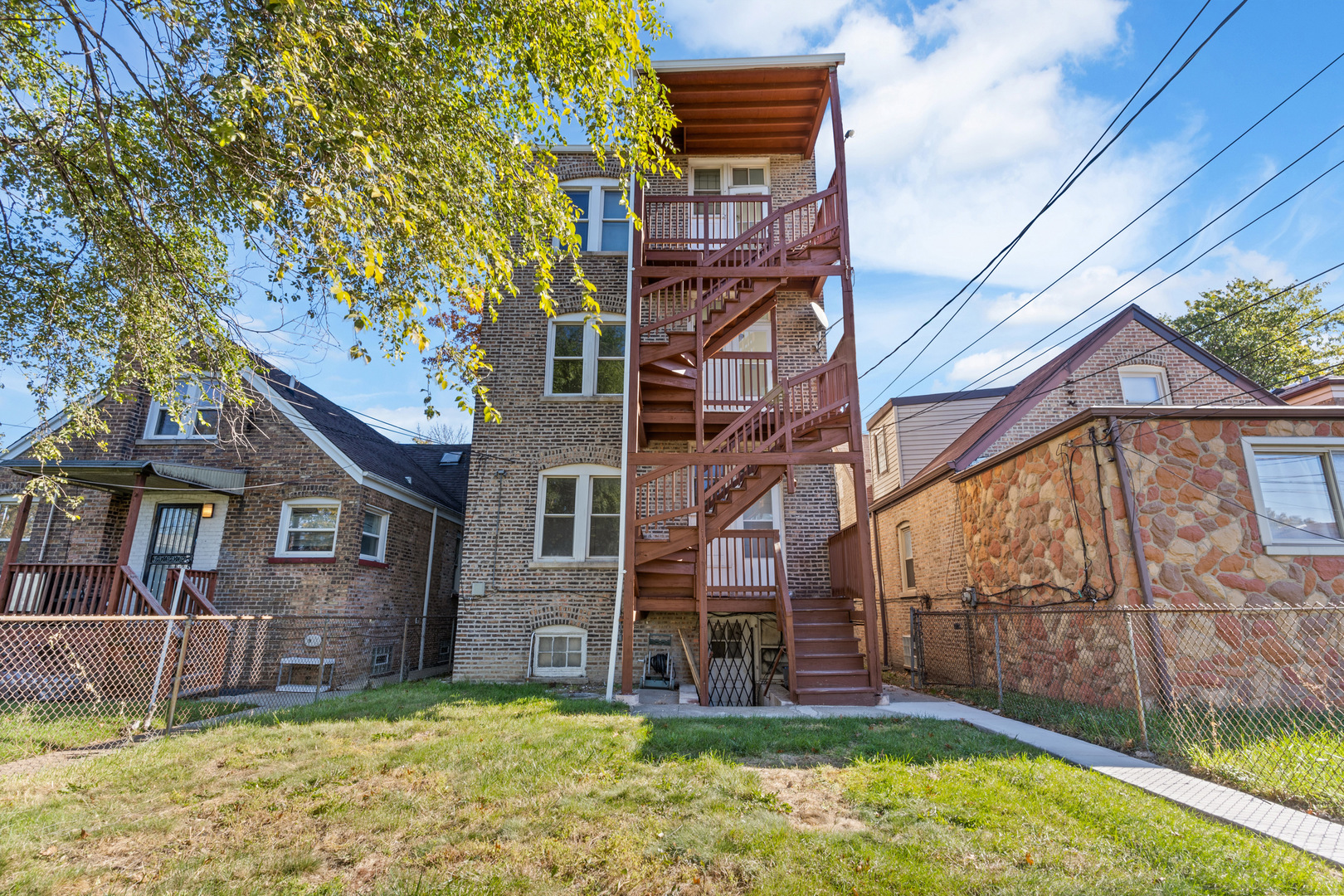 10342 South Calumet Avenue, Unit 3 Chicago, IL 60628 - Photo 24 of 25 a view of a house with a big yard and large tree