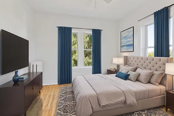 a bedroom with a bed and a flat screen tv