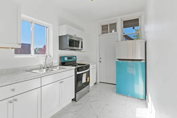 a kitchen with a sink and cabinets