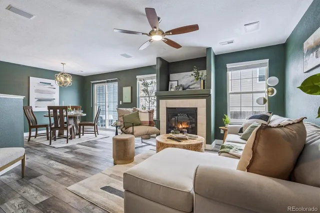 a living room with furniture and a fireplace