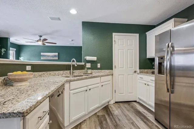 a kitchen with a sink and refrigerator