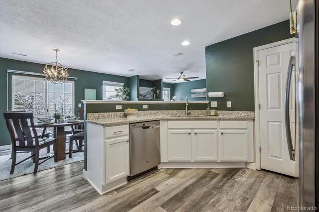 a bathroom with a granite countertop sink mirror and cabinets