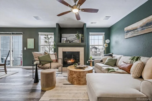 a living room with furniture and a fireplace