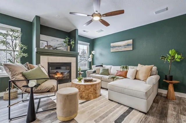a living room with furniture and a fireplace