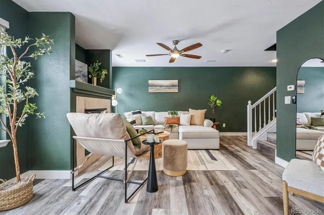 a living room with furniture and a wooden floor