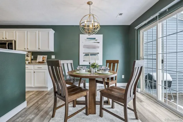 a view of a dining room with furniture window and wooden floor