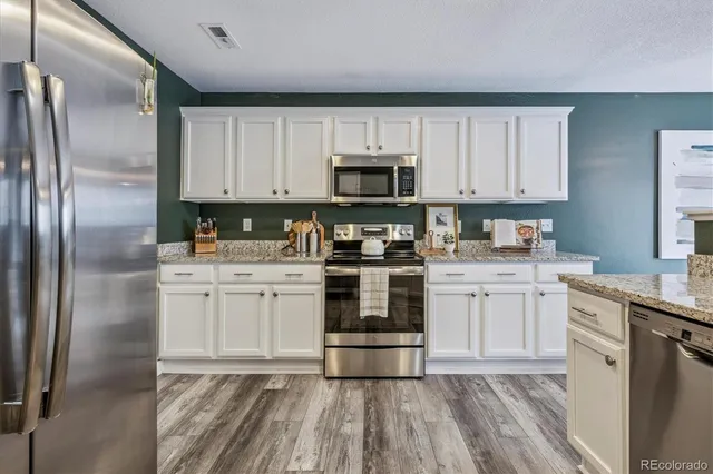 a kitchen with a refrigerator stove and sink