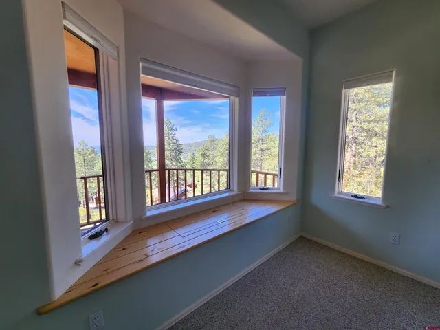 a spacious bathroom with a double vanity sink a large mirror a bathtub and