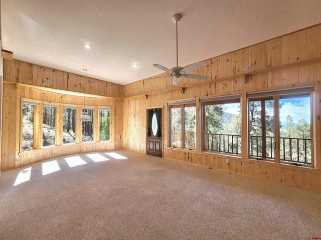 a view of a room with window and hardwood floor