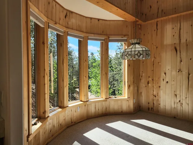 a view of an empty room with a window and a fireplace