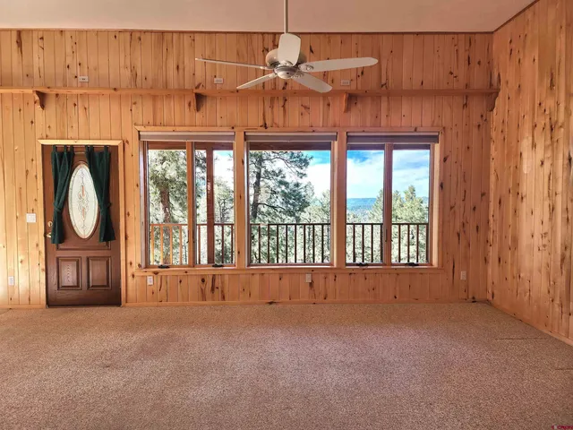 a kitchen with kitchen island granite countertop wooden cabinets and white appliances