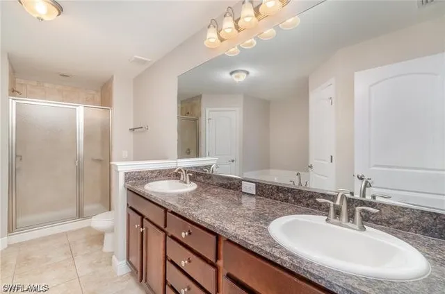 an empty room with a window and a ceiling fan