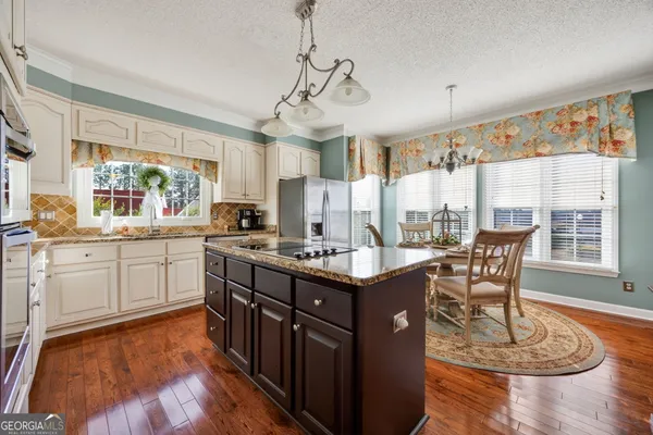 a kitchen with a sink stove and refrigerator