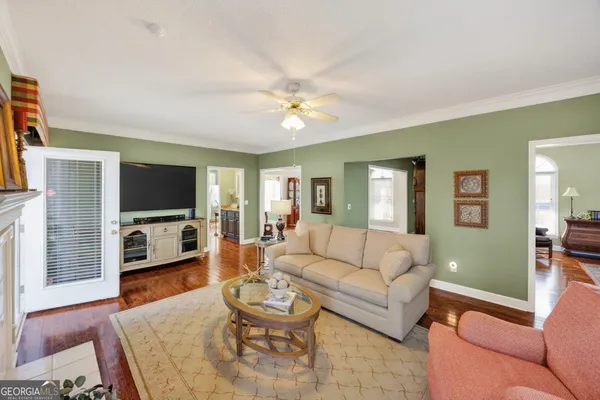 a living room with furniture and a flat screen tv