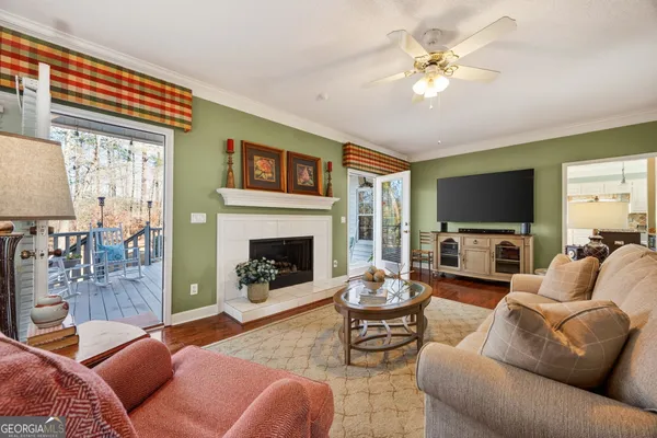 a living room with furniture a flat screen tv and a fireplace