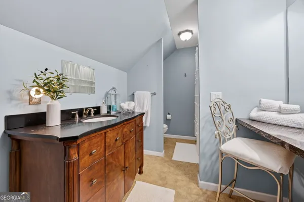 a view of a patio with table and chairs with wooden floor and fence