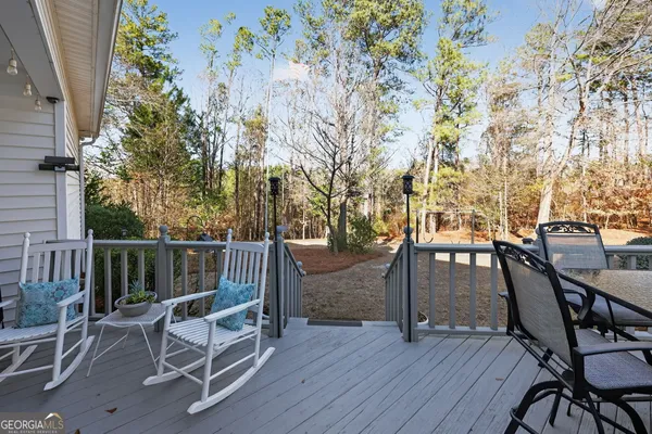 a view of a chairs and table on the wooden deck