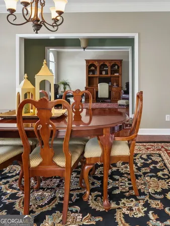 a view of a dining room with furniture and chandelier