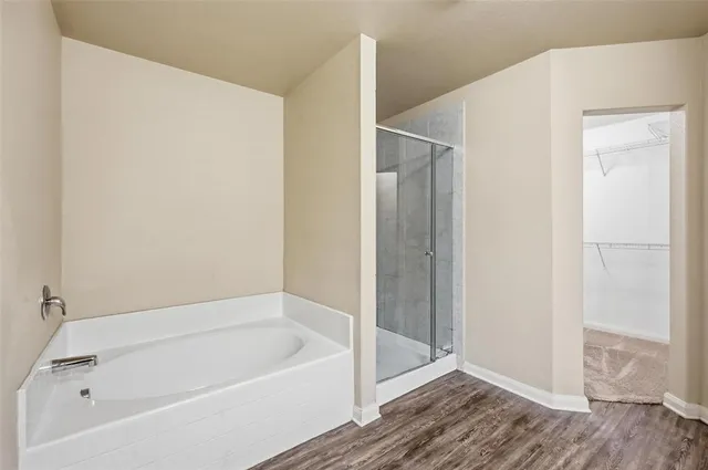 a bathroom with a bathtub and a shower