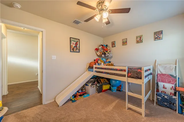 a bedroom with furniture and fan