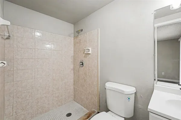a bathroom with a shower and a toilet