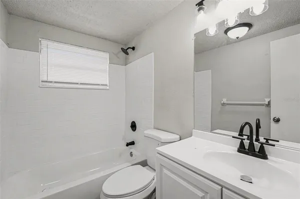 a bathroom with a sink toilet vanity and shower