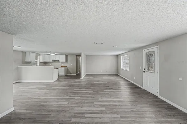 a view of a kitchen with wooden floor