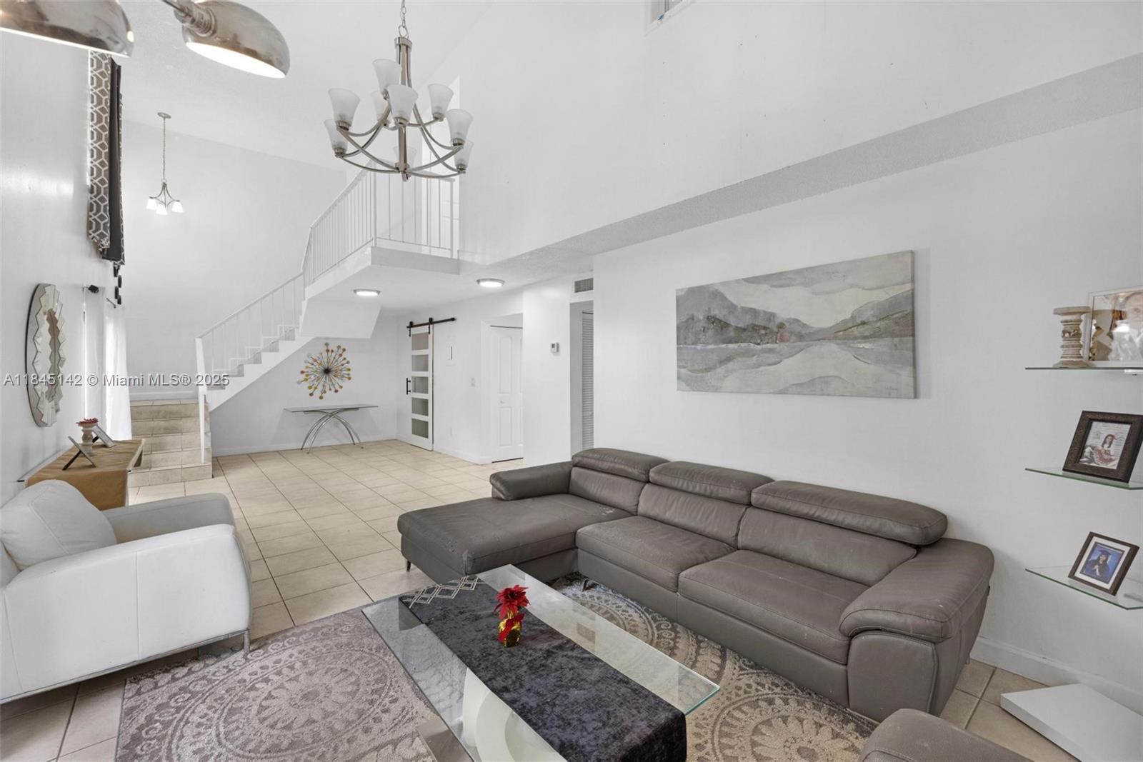 8500 Southwest 109th Avenue, Unit 6112 Miami, FL 33173 - Photo 1 of 52 a living room with furniture and a chandelier