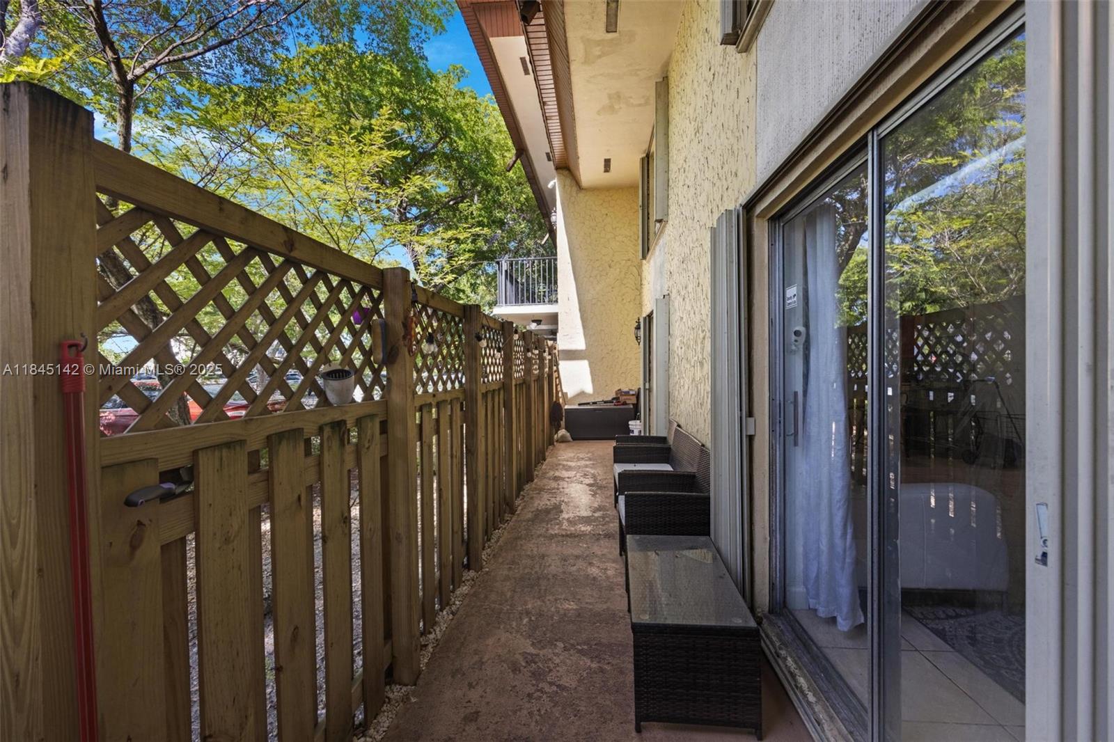 8500 Southwest 109th Avenue, Unit 6112 Miami, FL 33173 - Photo 16 of 52 a view of a porch with wooden floor and stairs