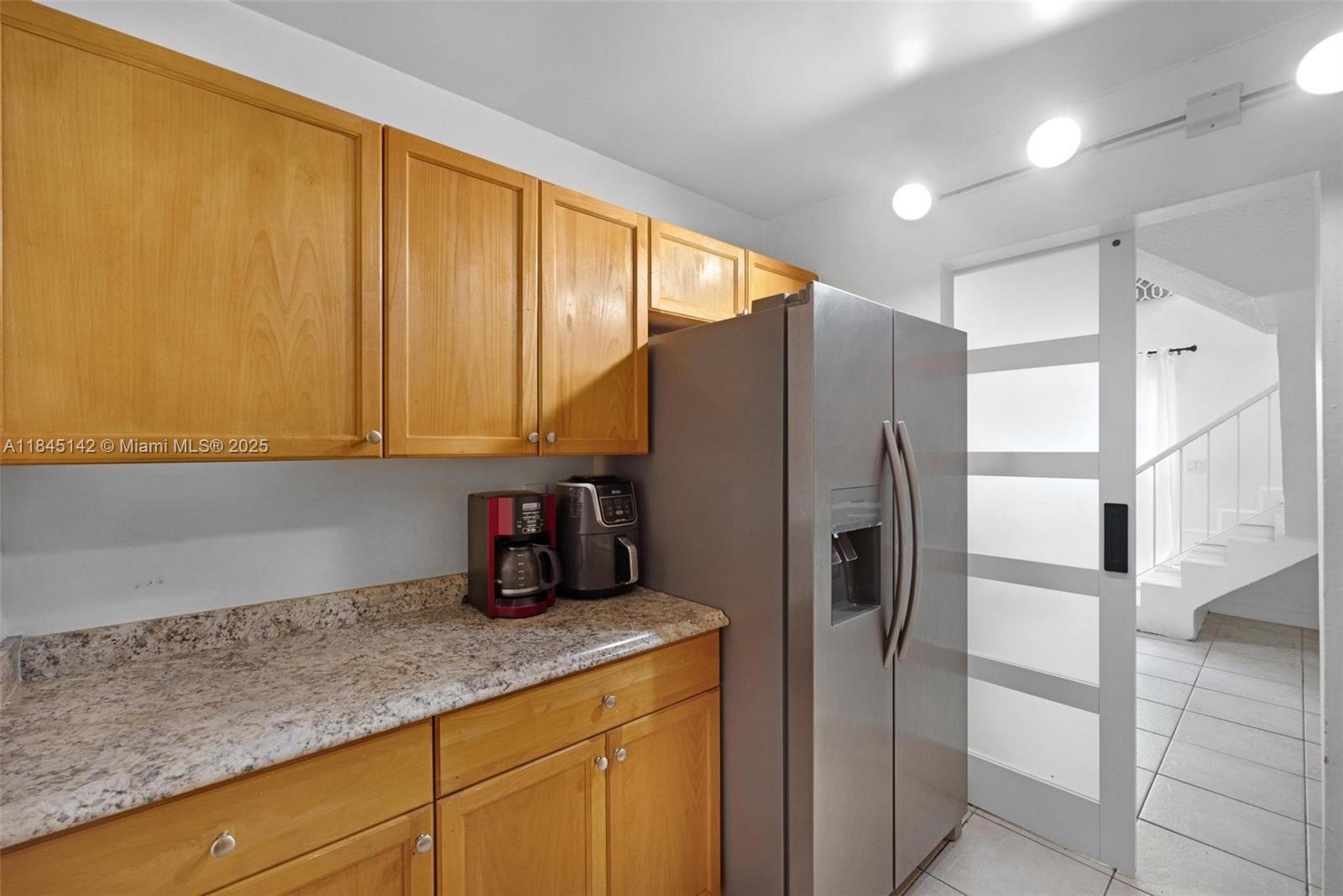 8500 Southwest 109th Avenue, Unit 6112 Miami, FL 33173 - Photo 19 of 52 a kitchen with stainless steel appliances granite countertop a refrigerator and cabinets