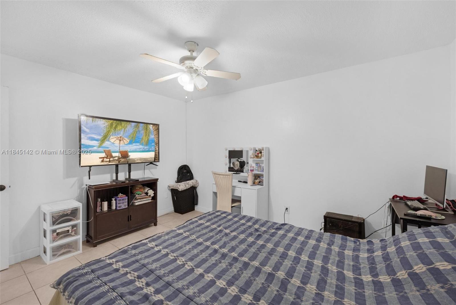 8500 Southwest 109th Avenue, Unit 6112 Miami, FL 33173 - Photo 25 of 52 a bedroom with a bed and a flat screen tv