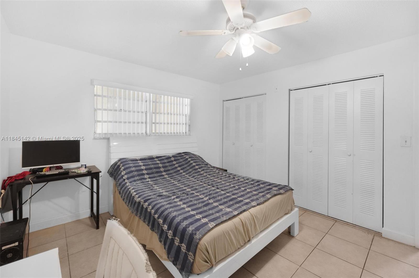 8500 Southwest 109th Avenue, Unit 6112 Miami, FL 33173 - Photo 26 of 52 a bedroom with a bed and a chandelier