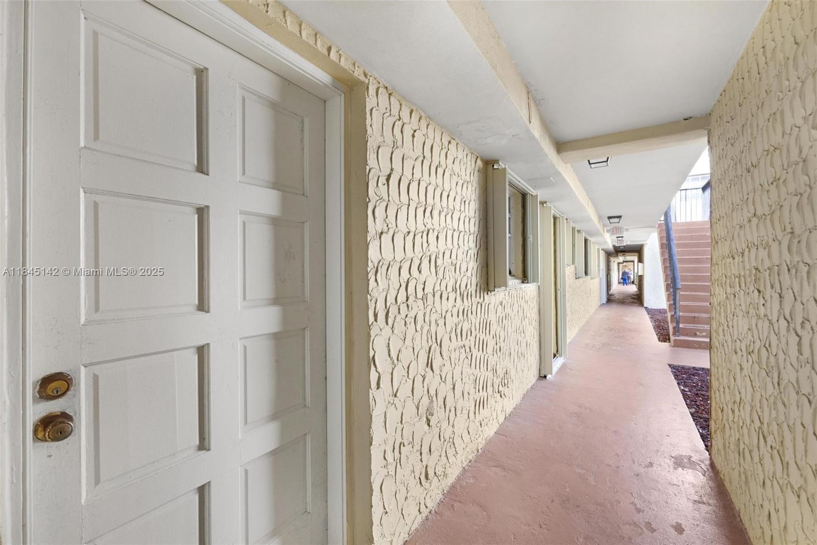 8500 Southwest 109th Avenue, Unit 6112 Miami, FL 33173 - Photo 33 of 52 a view of a hallway with wooden floor and windows